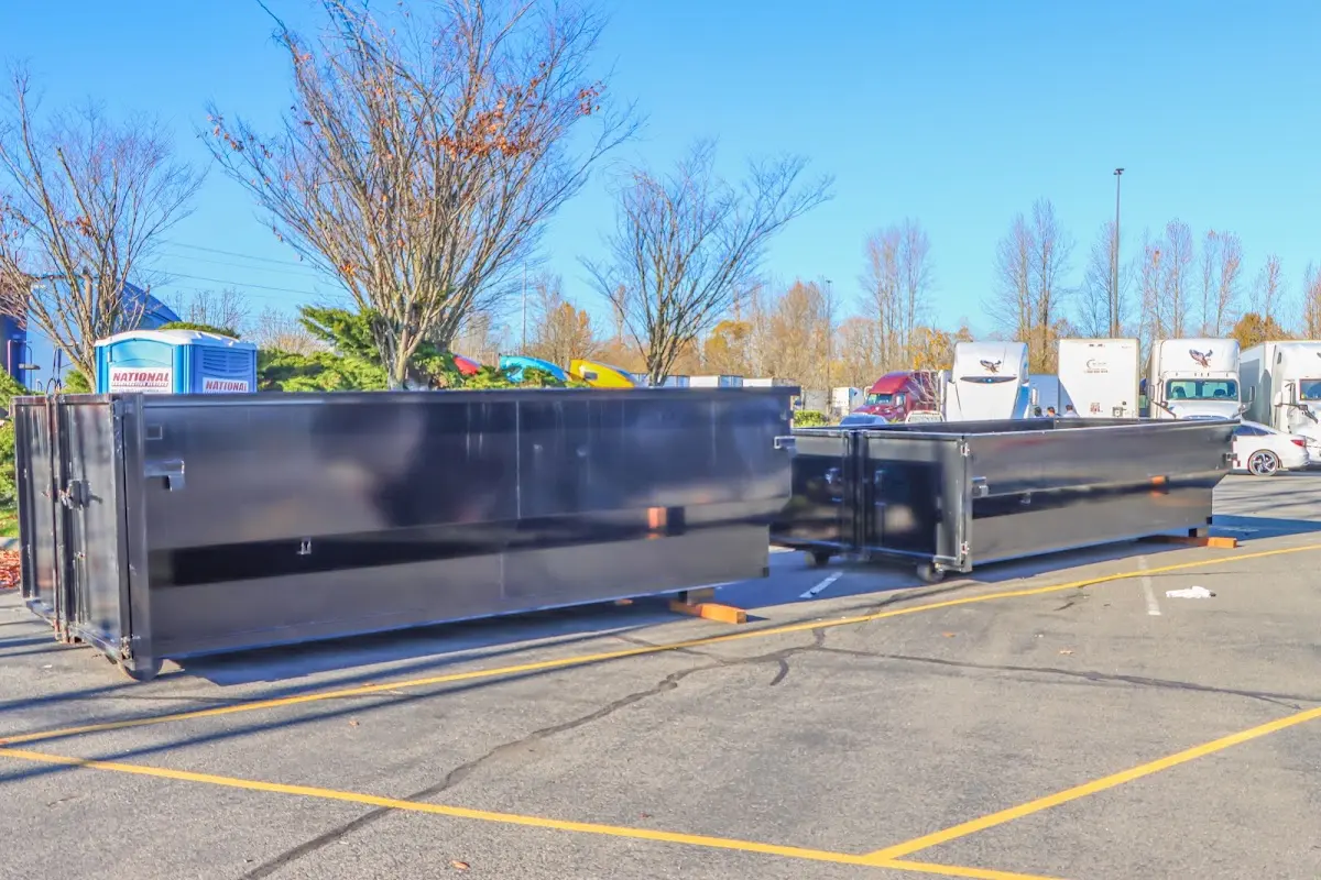 Professional dumpster rental service with roll-off container on residential driveway in Merrydale
